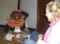 Masked dancer interacting with participant